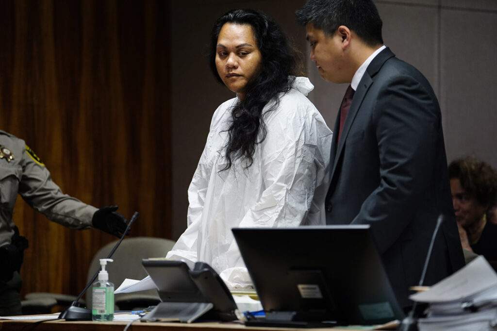 Sina Pili, 39, leaves the courtroom after her arraignment on manslaughter charges Thursday, March 13, 2025, in Honolulu. Public defender Samson Shigetomi remains at the table. Her adopted daughter Azaeliyah Pili-Ah You died Dec. 22, 2023. Emergency service technicians found Azaeliyah unresponsive with bruises on her body and face in Pili’s Lā’ia home. Pili worked as a Department of Education behavioral health specialist since 2015. (Kevin Fujii/Civil Beat/2025)