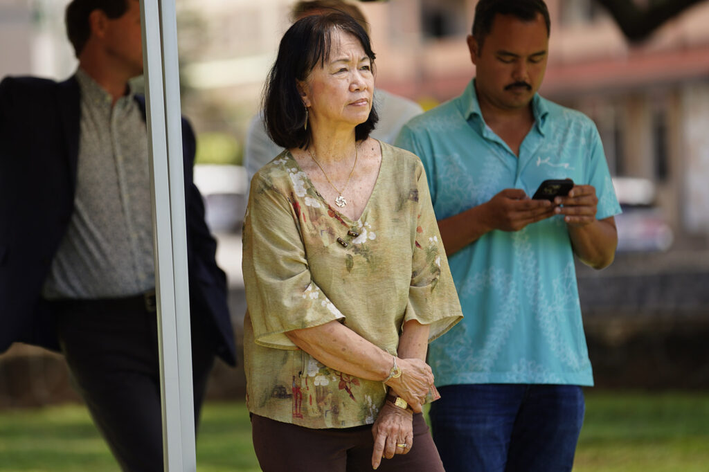 Executive Director of the Institute for Human Services Connie Mitchell listens during Mayor Rick Blangiardi’s news briefing asking for more homeless advocates Tuesday, April 15, 2025, at A’ala Park in Honolulu. (Kevin Fujii/Civil Beat/2025)