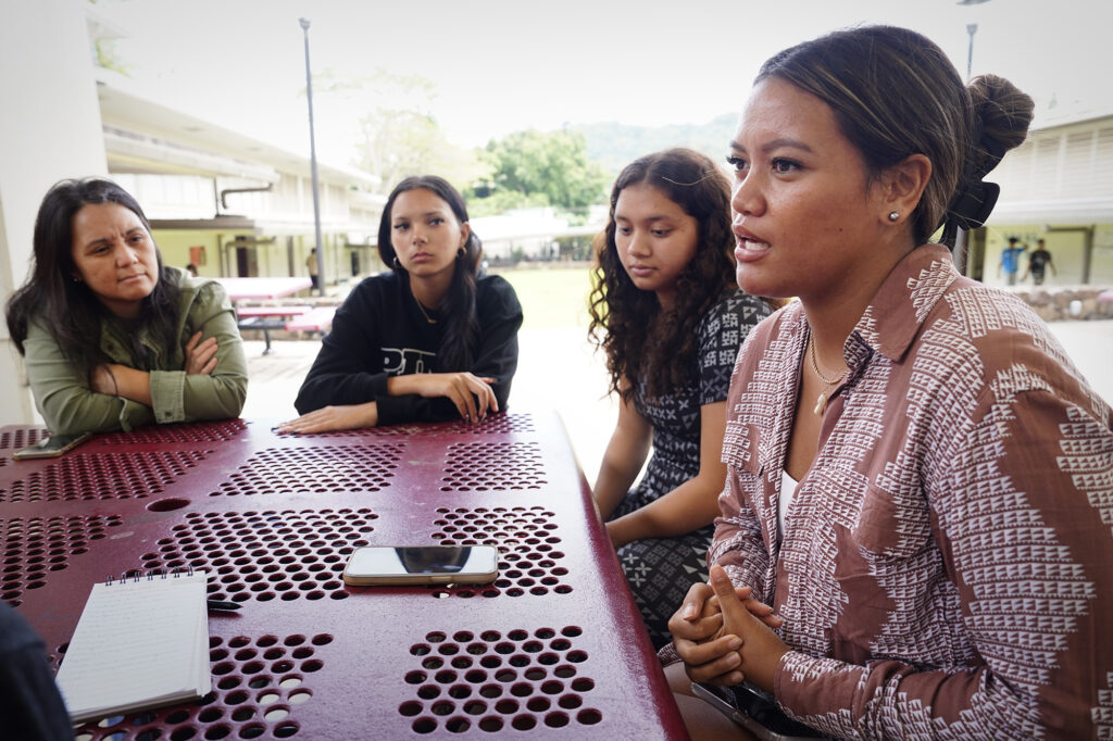 Castle High School students talk about food and school lunches Monday, May 5, 2025, in Kāneʻohe. They are teacher Lauren Pokipala, from left, and juniors Keira Torres, Tayli Kahoopii and Hallia Tom-Jardine. (Kevin Fujii/Civil Beat/2025)