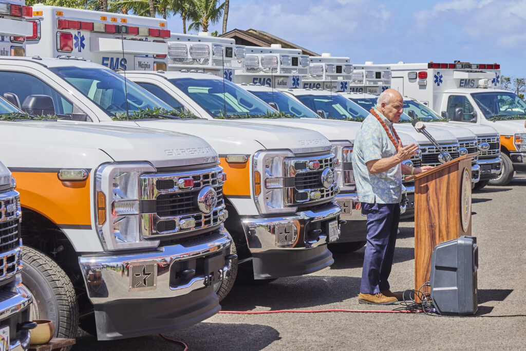 On Tuesday May 7th, Honolulu Mayor Rick Blangiardi, a number of Honolulu Council members and several EMS leaders gathered at Keehi Beach Park to partake in an Hawaiian blessing.  The blessing was for a group of 17 new emergency response vehicles that will be positioned across O’ahu within the month of May.  The units  include 14 EMS Ambulances, 2 C.O.R.E rigs and an AmbuBus that can support mass casualty events and evacuations.  Another 4 additional Ambulances will arrive in the Fall, completing the largest one time deployment of emergency vehicles(David Croxford/Civil Beat/2025)