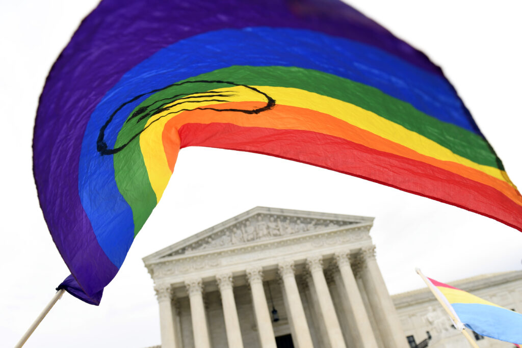 FILE - In this Oct. 8, 2019, file photo, protesters gather outside the Supreme Court in Washington, where the Supreme Court is hearing arguments in the first case of LGBT rights since the retirement of Supreme Court Justice Anthony Kennedy. LGBT-rights activists are looking ahead as they celebrate a major victory in the Supreme Court regarding job discrimination, They hope the June 15, 2020, decision spurs action against other forms of bias against their community and undermines the Trump administration’s near-total ban on military service by transgender people. (AP Photo/Susan Walsh, File)