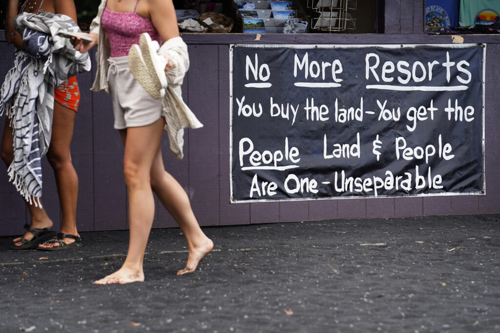 A sign at Punaluʻu Black Sand Beach is photographed Friday, May 23, 2025, in Pāhala. Developers Black Sand Beach LLC defaulted on a $3.4 million mortgage. A district court ordered the property they planned to develop into residential, tourist and commercial into foreclosure. (Kevin Fujii/Civil Beat/2025)