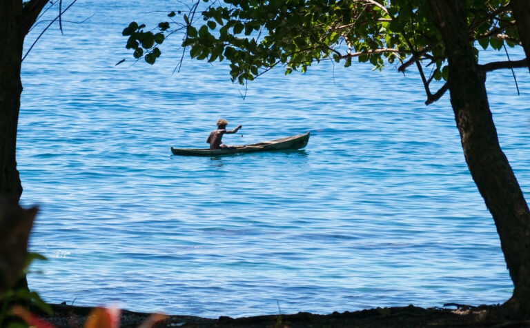 A Solomon Islander catches a small fish off the coast of Guadalcanal. (Nathan Eagle/Civil Beat/2022)