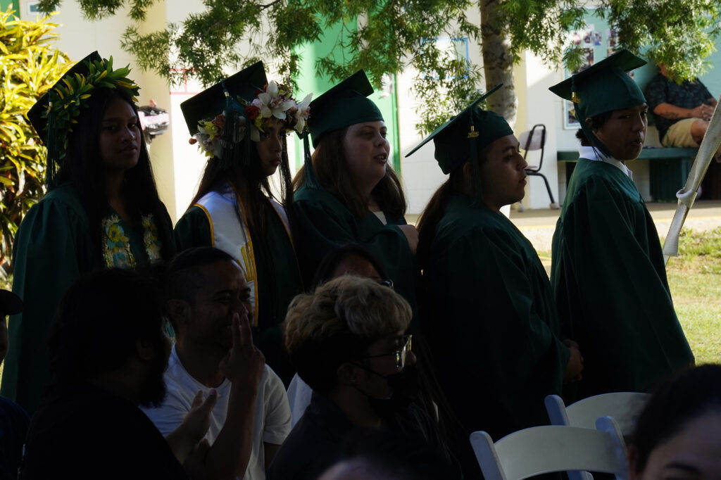Five of seven Hawaiʻi School for the Deaf and Blind seniors line up as the graduating class of 2025Wednesday, May 28, 2025, in Honolulu. Thanicia Gideon, from left, Odreigh Maskell, Tessie Radle, Zion Sale and Mikaiah Ventura wait to be announced. (Kevin Fujii/Civil Beat/2025)