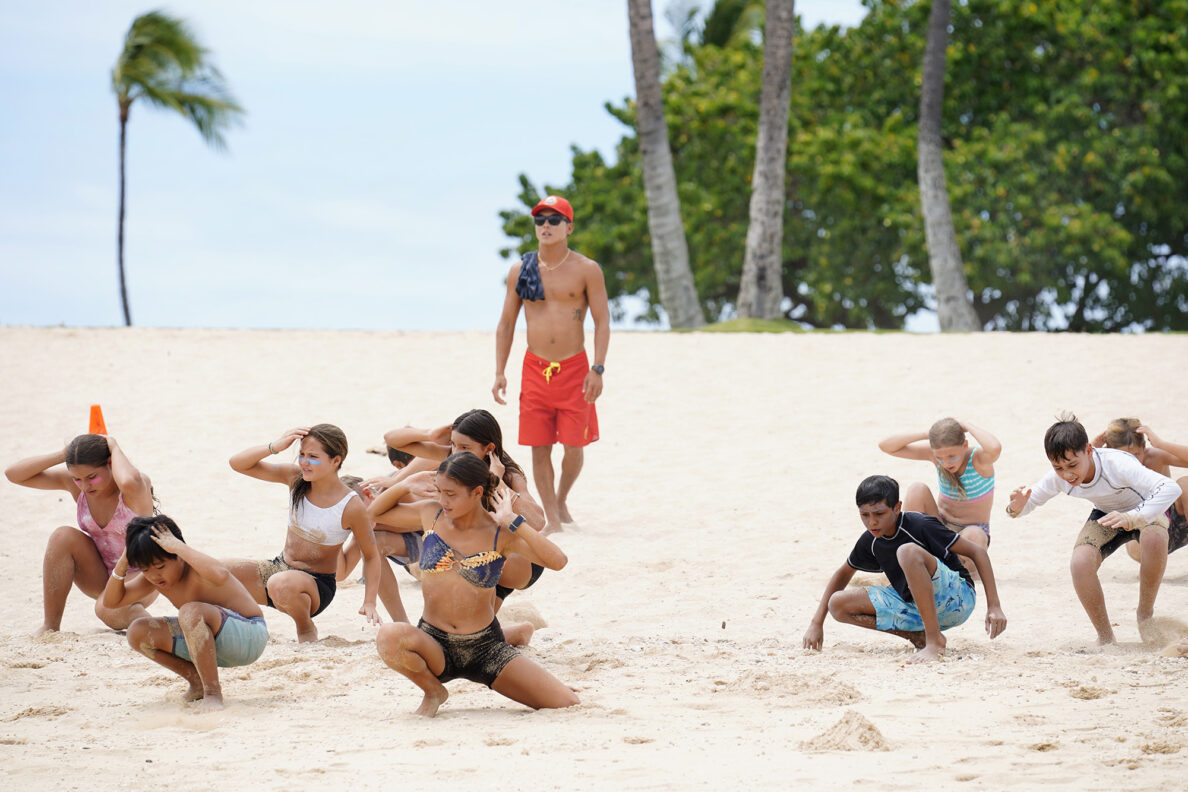 Honolulu Ocean Safety Department lifeguard Jedidiah Wataru runs Junior Lifeguard Program participants through beach fitness exercises at Ko’olina Wednesday, June 25, 2025, in Kapolei. (Kevin Fujii/Civil Beat/2025)