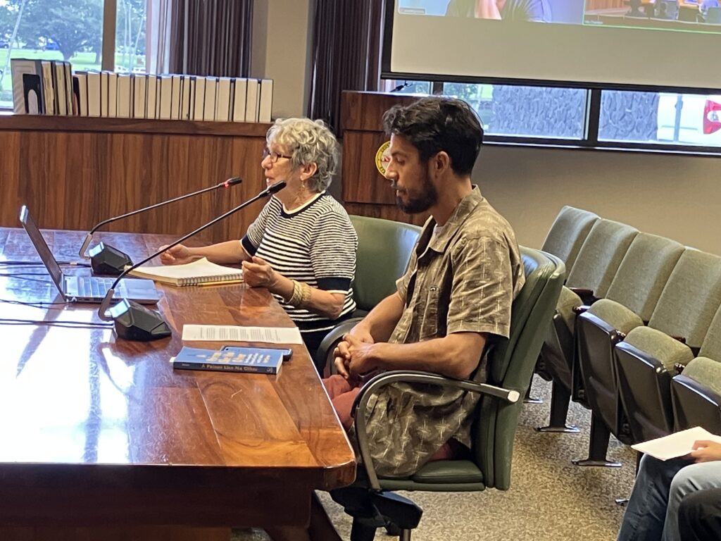 Kristine Kubat and Justin Canelas testify before the Hawaiʻi County Environmental Management Commission in Hilo.