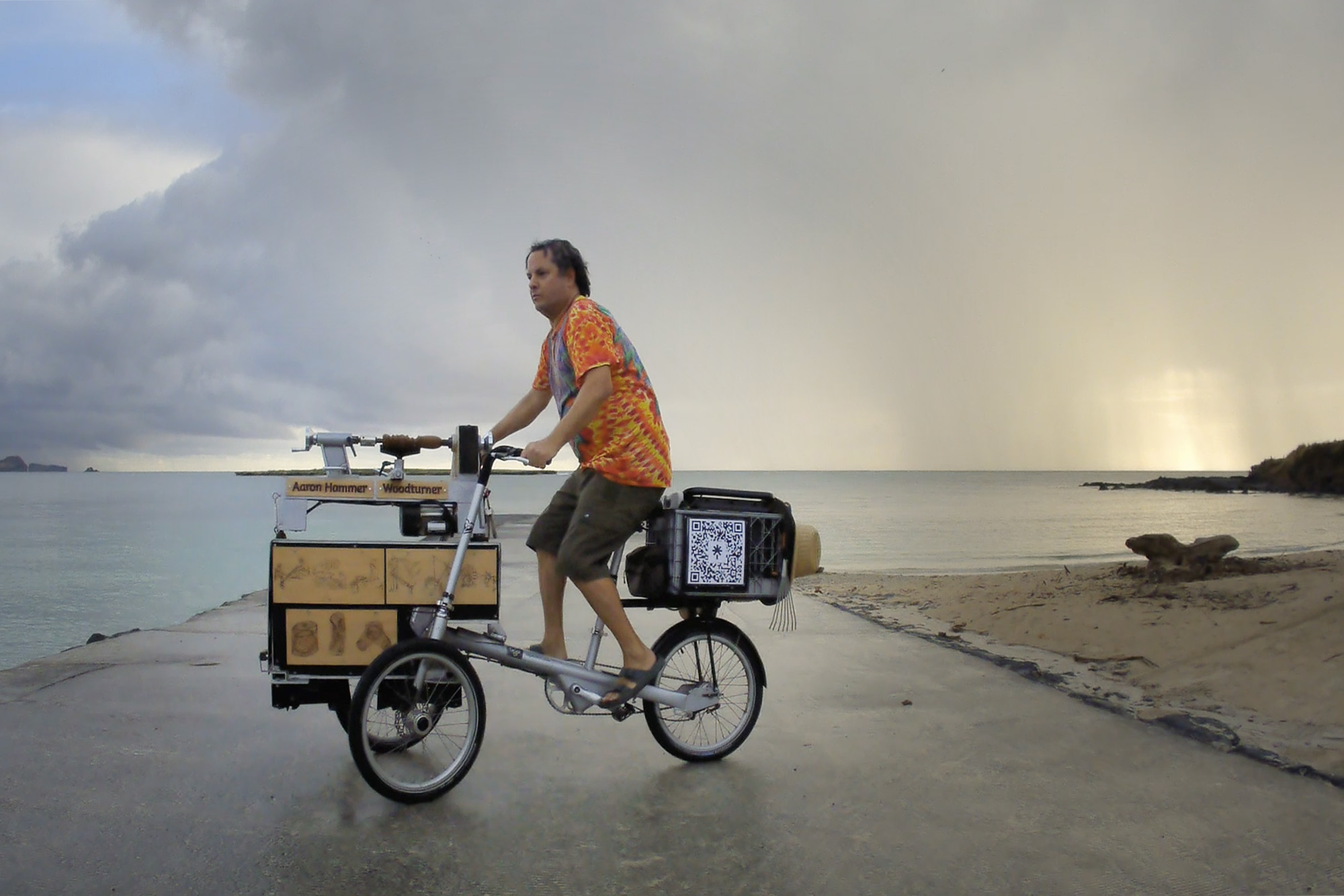 Rain on the horizon makes woodturner Aaron Hammer head for the covered shelters at Kailua Beach Park Wednesday, July 2, 2025, in Kailua. Rain is less than ideal for his woodturning lathe. Still image taken from video. (Kevin Fujii/Civil Beat/2025)