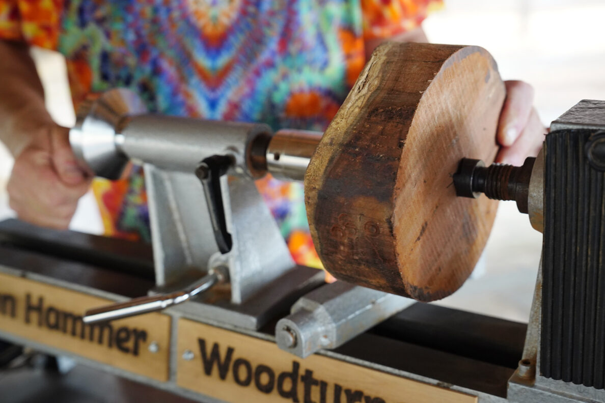 Woodturner Aaron Hammer places the milo wood between the tail and head of his lathe Wednesday, July 2, 2025, in Kailua. (Kevin Fujii/Civil Beat/2025)