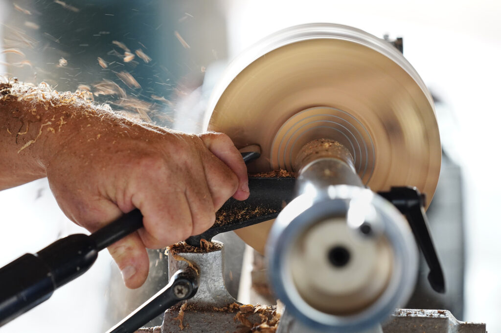 Woodturner Aaron Hammer begins to shape the foot and exterior of a soon-to-be-milo-wood bowl Wednesday, July 2, 2025, in Kailua. (Kevin Fujii/Civil Beat/2025)