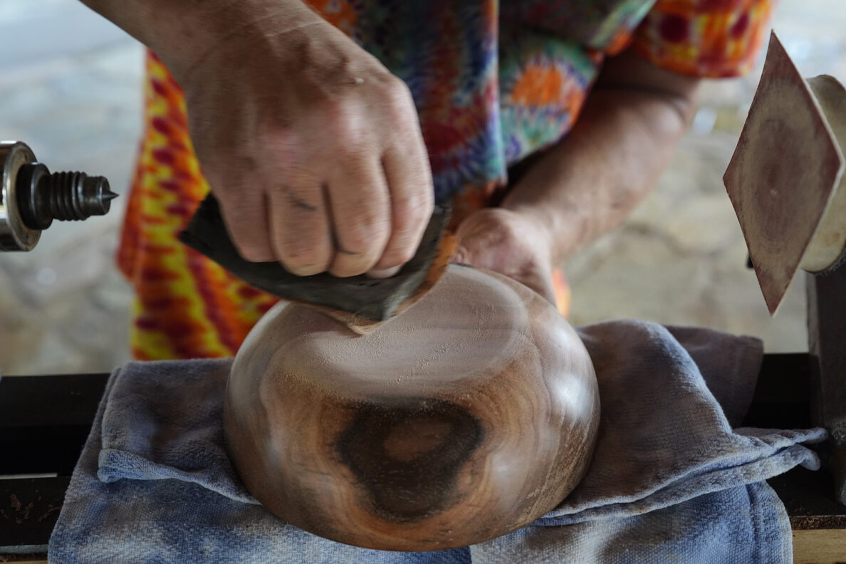 Woodturner Aaron Hammer sands the base of a newly created milo-wood bowl after removing the remaining foot Wednesday, July 2, 2025, in Kailua. (Kevin Fujii/Civil Beat/2025)