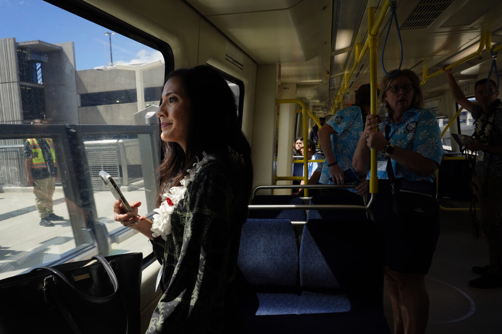 Council member Val Aquino Okimoto watches the Lelepaua Daniel K. Inouye International Airport station approach during the inaugural ride of the Skyline segment two Wednesday, Oct. 15, 2025, in Honolulu. The commuter train now extends past Hālawa Aloha Stadium to Kalihi’s Kahauiki Middle Street Transit Center. (Kevin Fujii/Civil Beat/2025)