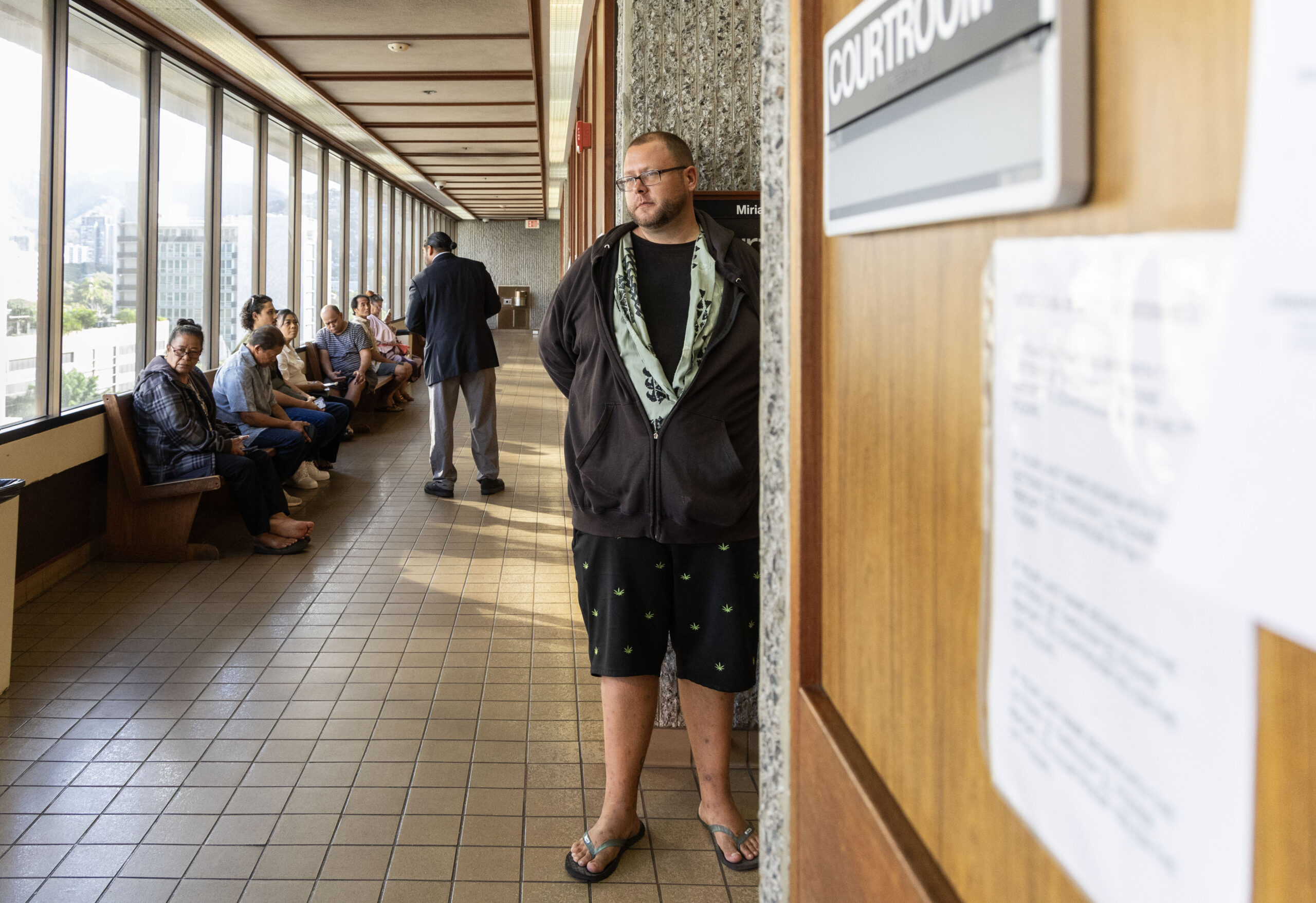 Kaleb Hoosier waits in the hallway of Honolulu District Court before appearing for multiple sit-lie citations. The court issued a continuance in his cases. Photo by Cindy Ellen Russell