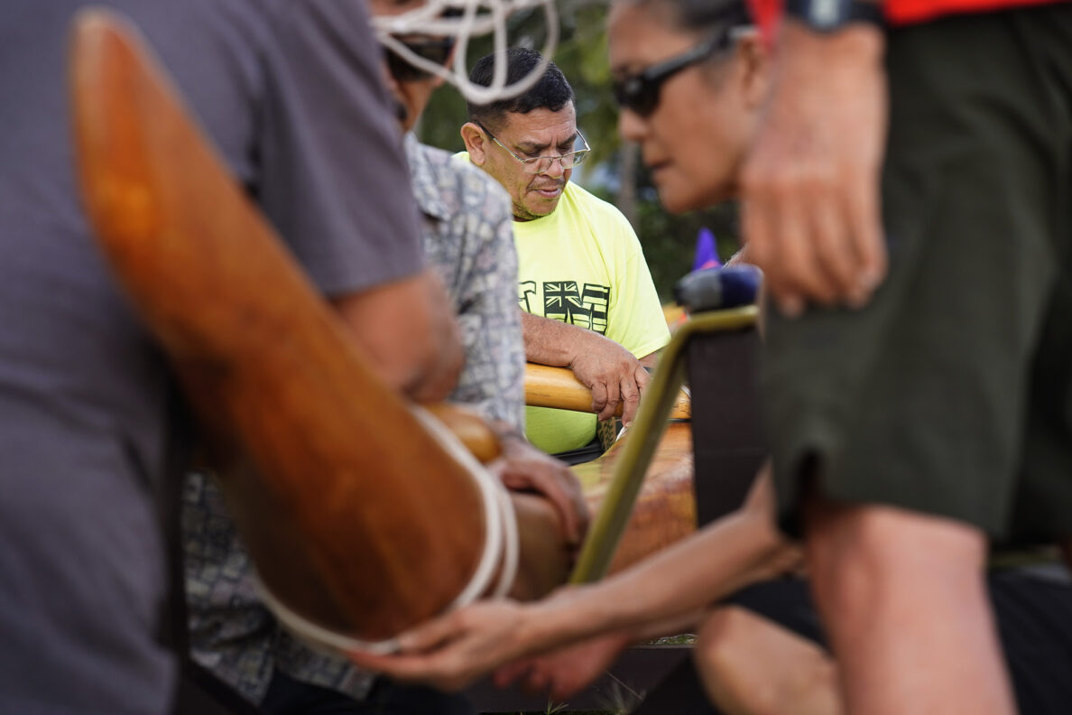 Ryan Olivares lanalana, or attaches the ama (outrigger float) to the ‘iako  (boom), to prepare Prince Prince Jonah Kūhiō Kalanianaʻole’s racing canoe, the A‘a, at Ke‘ehi Lagoon Friday, Nov. 7, 2025, in Honolulu. (Kevin Fujii/Civil Beat/2025)