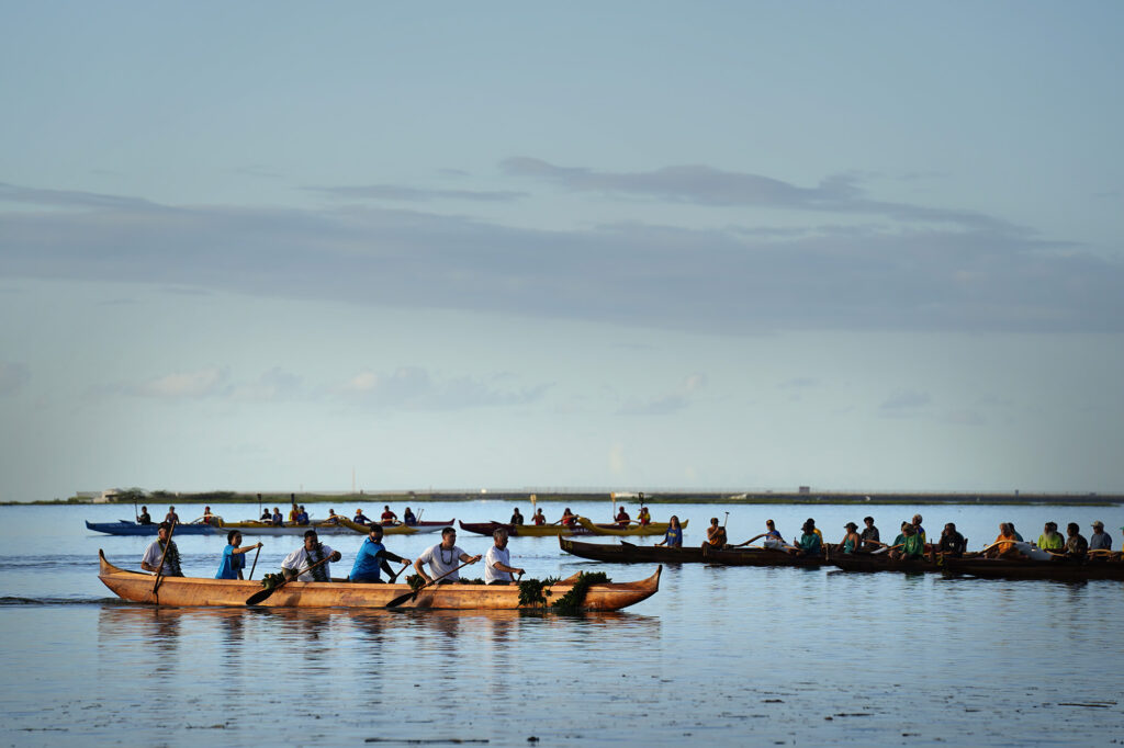 The A‘a returns to shore after its ceremonial blessing and paddle at Ke‘ehi Lagoon Saturday, Nov. 8, 2025, in Honolulu. The koa wa‘a was Prince Jonah Kūhiō Kalanianaʻole’s famous koa racing canoe. Tom Lenchanko, who, with the Hawaiian Civic Club of Wahiawa, are the caretakers of the Kukaniloko Birthstones where aliʻi were born. Lenchanko said that light always finds the aliʻi and they glow. (Kevin Fujii/Civil Beat/2025)