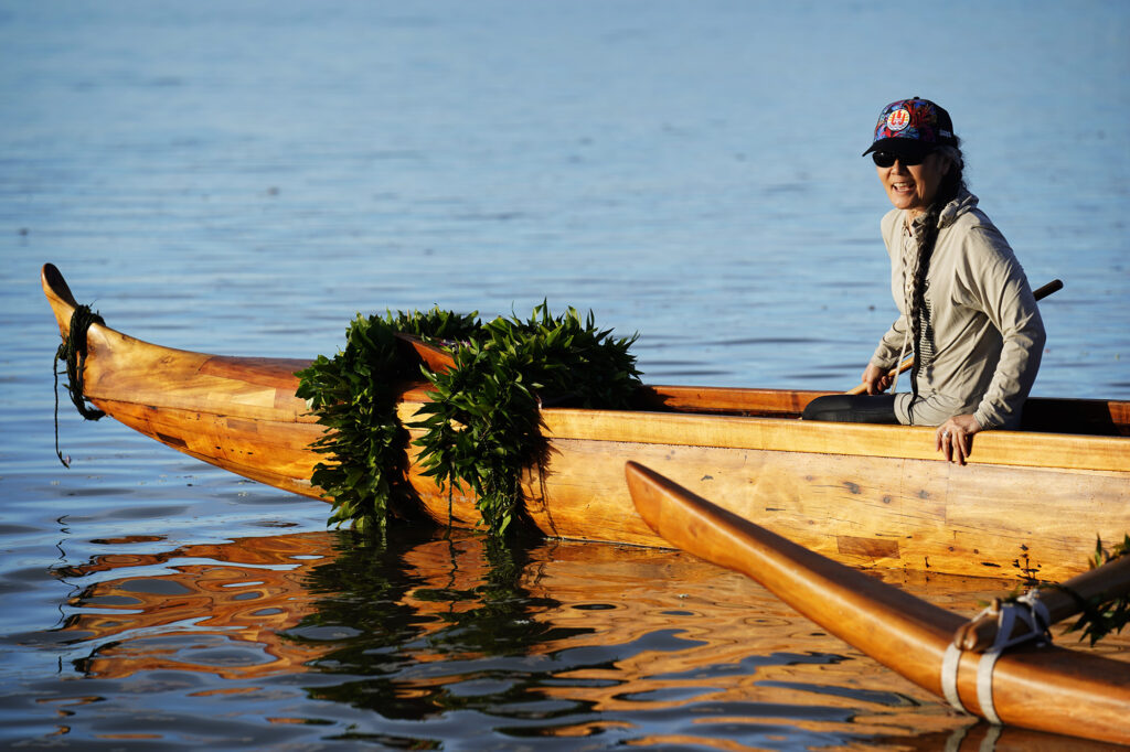 Michi Wong with the Friends of Hōkūleʻa and Hawaiʻiloa, prepares to paddle the A‘a for its second lap after the ceremonial blessing and inaugural paddle at Ke‘ehi Lagoon Saturday, Nov. 8, 2025, in Honolulu. The koa wa‘a was Prince Jonah Kūhiō Kalanianaʻole’s famous koa racing canoe. (Kevin Fujii/Civil Beat/2025)