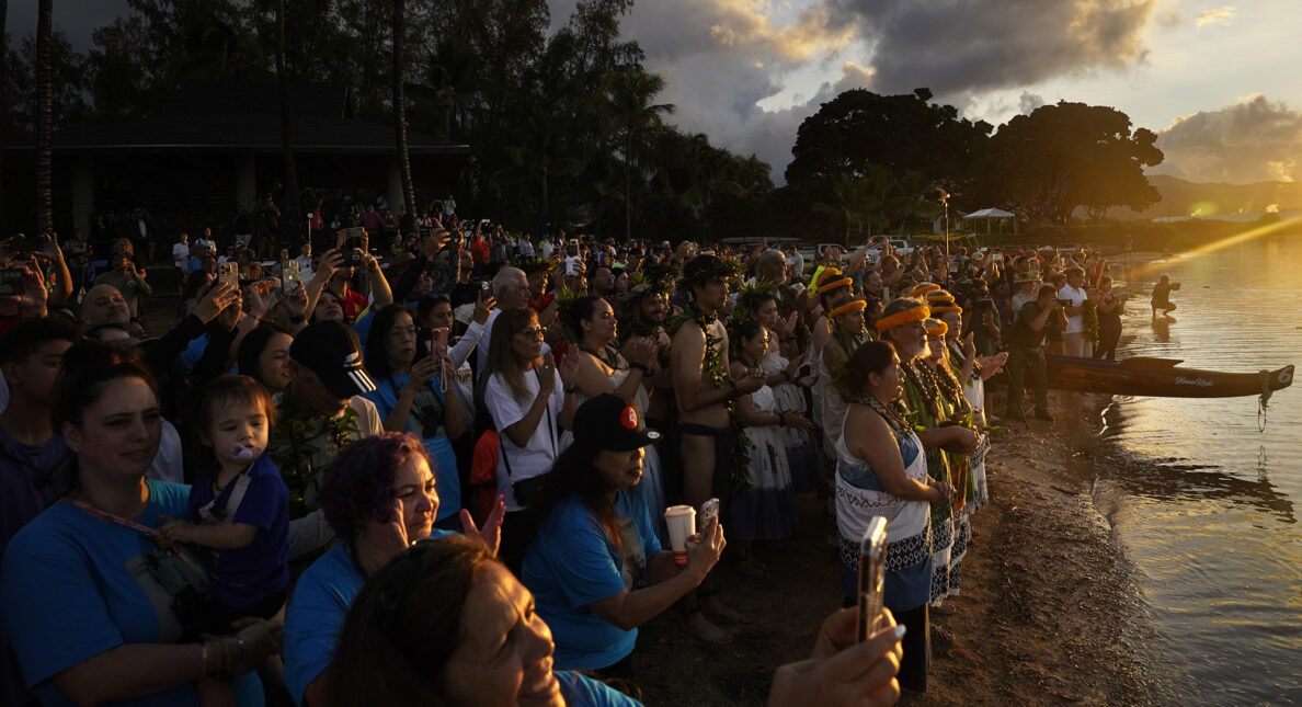 Cultural practitioners and the crowd watch Prince Jonah Kūhiō Kalanianaʻole’s famous koa racing canoe named the A‘a return to the ocean Saturday, Nov. 8, 2025, in Honolulu. (Kevin Fujii/Civil Beat/2025)