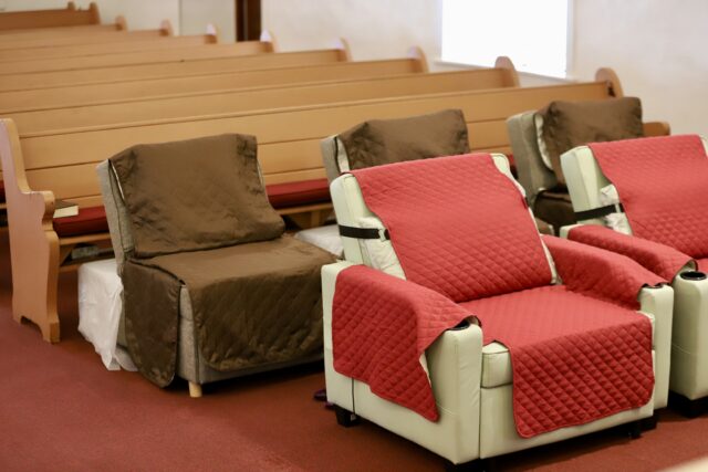 Rev. Dr. Kimberly Fong said she and other church leaders spent more than a year preparing Po'okela Church to house up to 22 volunteers at a time. So volunteers would have a place to sleep, the church purchased several reclining chairs and set them up wherever there was space — pastoral offices, storage rooms and even the church's main worship area. (Erin Nolan/Civil Beat/2025)