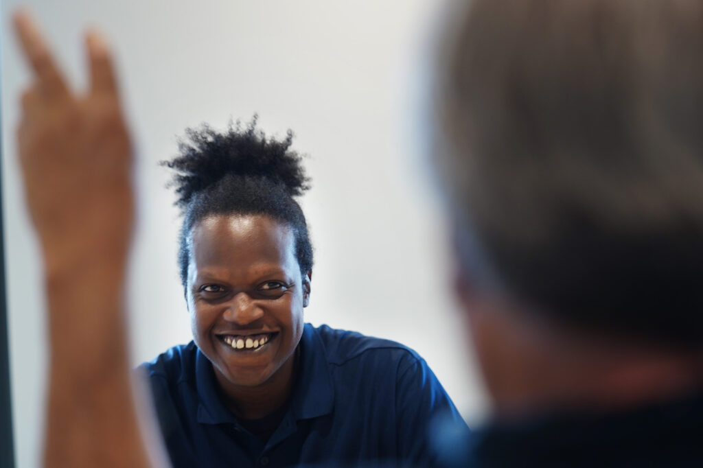 Camron Hurt, director of Common Cause Hawaiʻi, laughs as Civil Beat’s Chad Blair puts up “air quotes” during an  editorial board meeting Tuesday, Nov. 25, 2025, in Honolulu. (Kevin Fujii/Civil Beat/2025)
