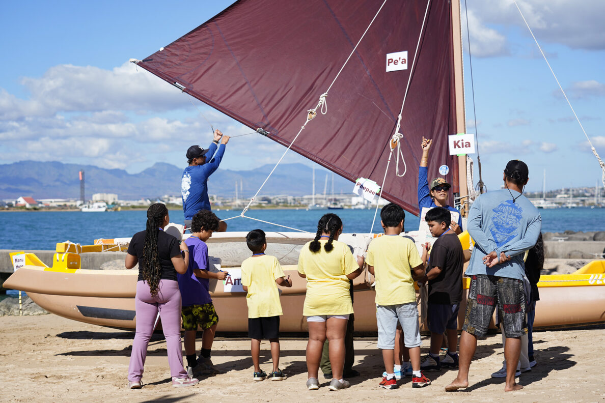 Tina Henline with Huli of Hilo talks about parts of a voyaging canoe with Kapālama Elementary School 4th graders during the Ho‘ākea Honolulu hands-on learning and experiencing event centered around traditional Hawaiʻian navigation and voyaging canoes Wednesday, Dec. 3, 2025, in Honolulu. Hawaiʻian voyaging traditions, cultural practices and ʻāina-based learning pairs with DOE curriculum to create a “Navigator Mindset”. (Kevin Fujii/Civil Beat/2025)