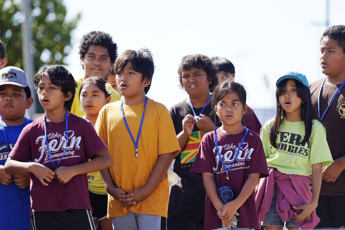 Fern Elementary School 4th graders sing a mele in ʻŌlelo Hawaiʻi to Polynesian Voyaging Society’s Nainoa Thompson during the Ho‘ākea Honolulu hands-on learning and experiencing event centered around traditional Hawaiʻian navigation and voyaging canoes Wednesday, Dec. 3, 2025, in Honolulu. Hawaiʻian voyaging traditions, cultural practices and ʻāina-based learning pairs with DOE curriculum to create a, “Navigator Mindset.” (Kevin Fujii/Civil Beat/2025)