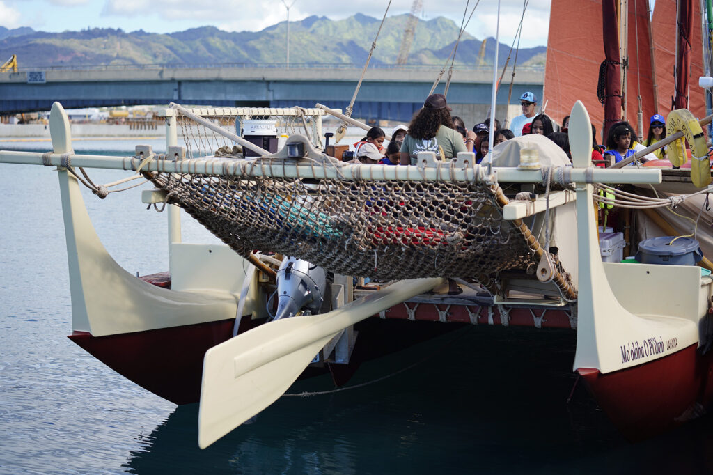 Kalihi Kai Elementary School 4th graders get a tour aboard the Mo‘okiha O Pi‘ilani during the Ho‘ākea Honolulu hands-on learning and experiencing event centered around traditional Hawaiʻian navigation and voyaging canoes Wednesday, Dec. 3, 2025, in Honolulu. The voyaging canoe belongs to Hui O Wa‘a Kaulua of Maui. Hawaiʻian voyaging traditions, cultural practices and ʻāina-based learning pairs with DOE curriculum to create a “Navigator Mindset”. (Kevin Fujii/Civil Beat/2025)