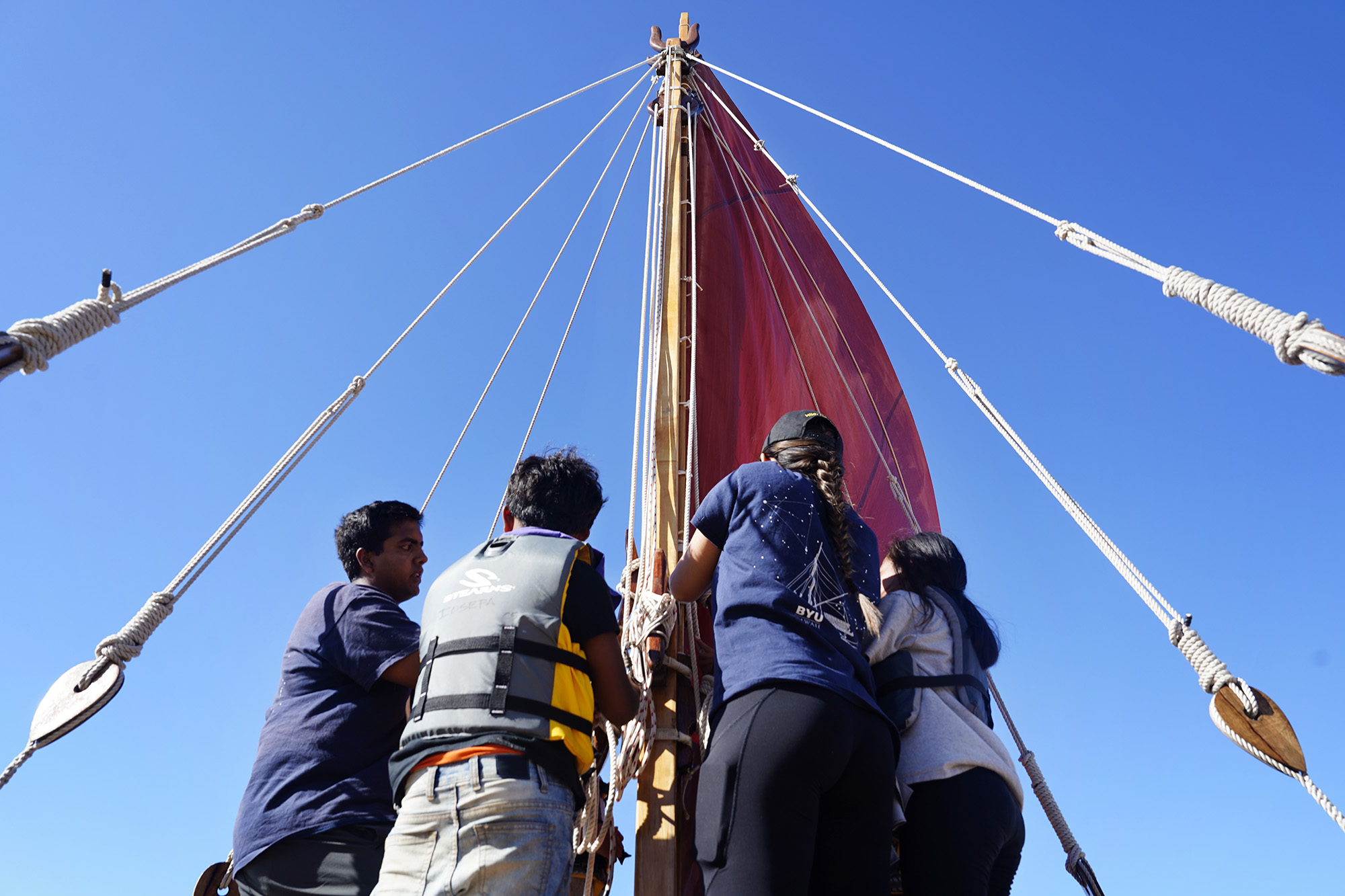 BYU Hawaiʻi’s Iosepa voyaging canoe crew teaches Kapālama Elementary School 4th graders to raise the sail during the Ho‘ākea Honolulu hands-on learning and experiencing event centered around traditional Hawaiʻian navigation and voyaging canoes Wednesday, Dec. 3, 2025, in Honolulu. Hawaiʻian voyaging traditions, cultural practices and ʻāina-based learning pairs with DOE curriculum to create a “Navigator Mindset”. (Kevin Fujii/Civil Beat/2025)