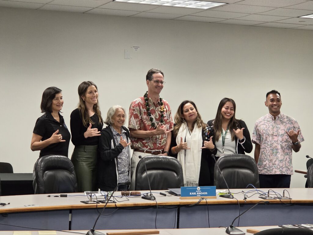 State Sen. Karl Rhoads poses for a photograph with immigrant advocates who testified at a state Senate Committee on Judiciary hearing.