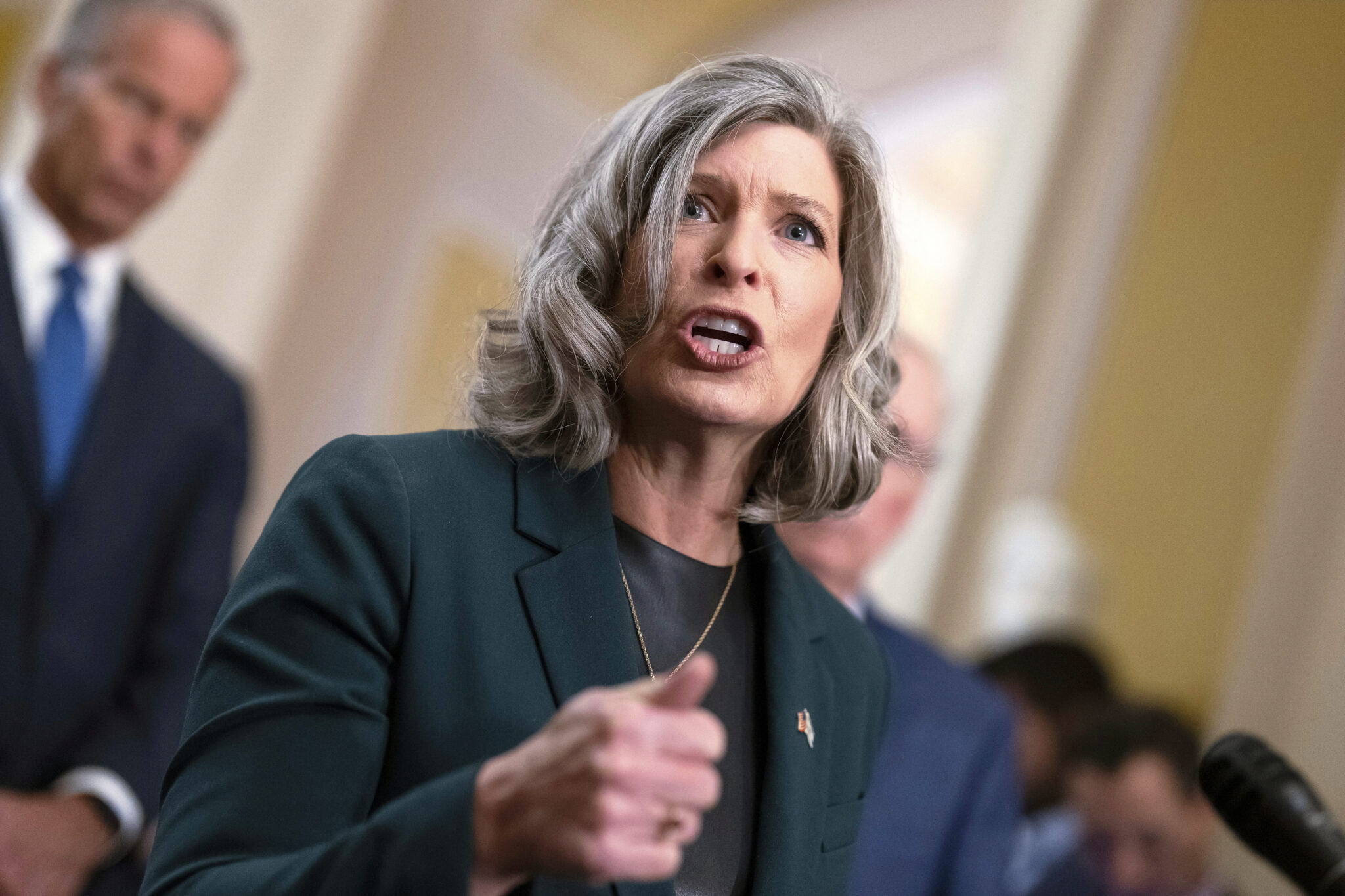 A woman gestures with her hand while speaking.