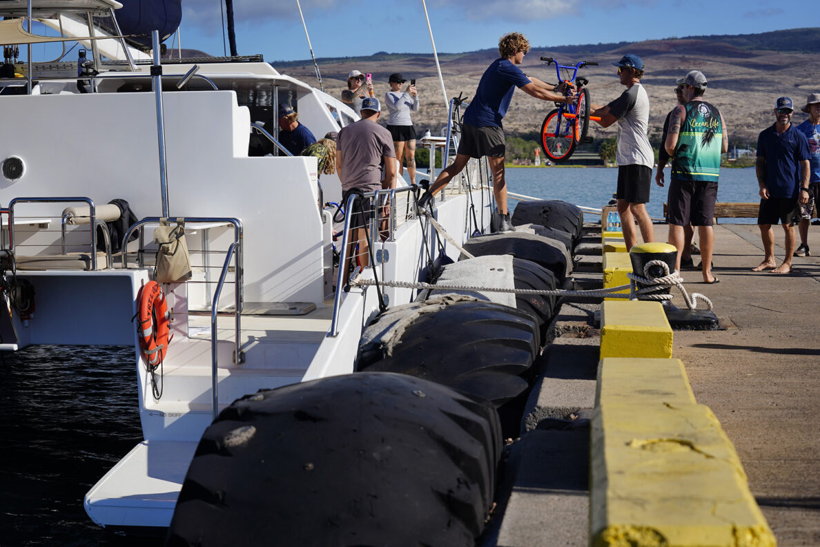 The Trilogy crew helps unload bikes for Jim Falk’s annual Christmas Kids Bike Build Wednesday, Dec. 10, 2025, at Molokaʻi Wharf in Kaunakakai. Approximately 450 new bicycles are built and will distributed to keiki in Maui County. (Kevin Fujii/Civil Beat/2025)