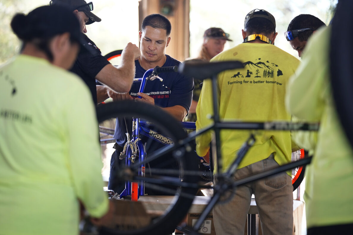 Maui Emergency Management Agency’s Justin Neuhart builds a bicycle during Jim Falk’s annual Christmas Kids Bike Build Wednesday, Dec. 10, 2025, in Kaunakakai, Molokaʻi. Approximately 450 new bicycles are built and will distributed to keiki in Maui County. (Kevin Fujii/Civil Beat/2025)