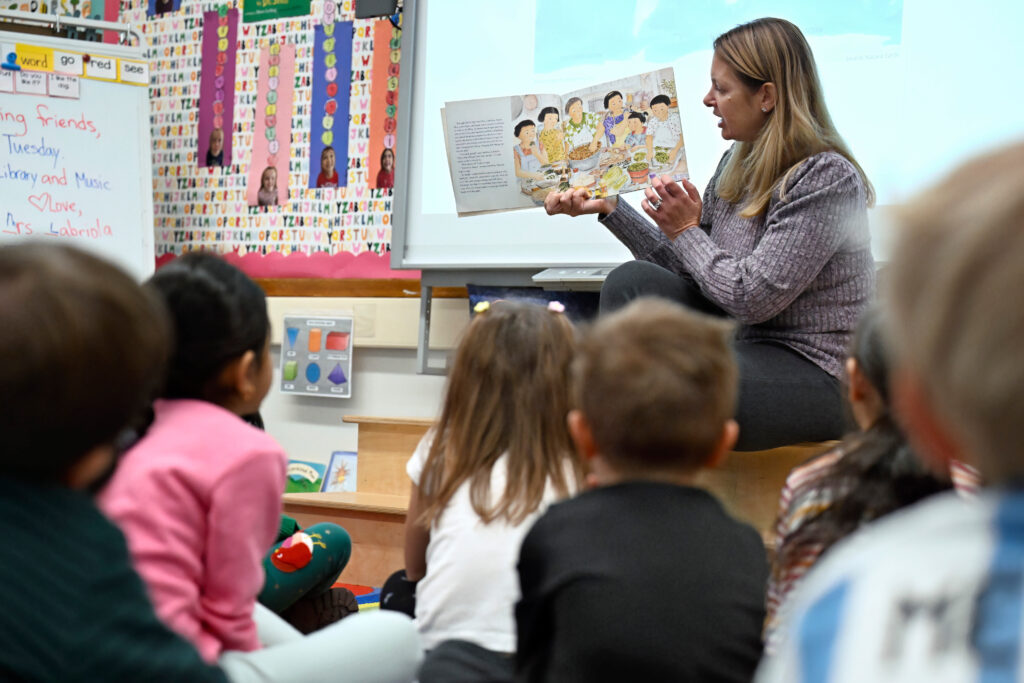 Kindergarten teacher Christin Labriola reads the book "Dumpling Soup" to her class, incorporating Asian American and Pacific Islander subjects in her class at Webster Hill Elementary School in West Hartford, Conn., on Dec. 2, 2025. (AP Photo/Jessica Hill)