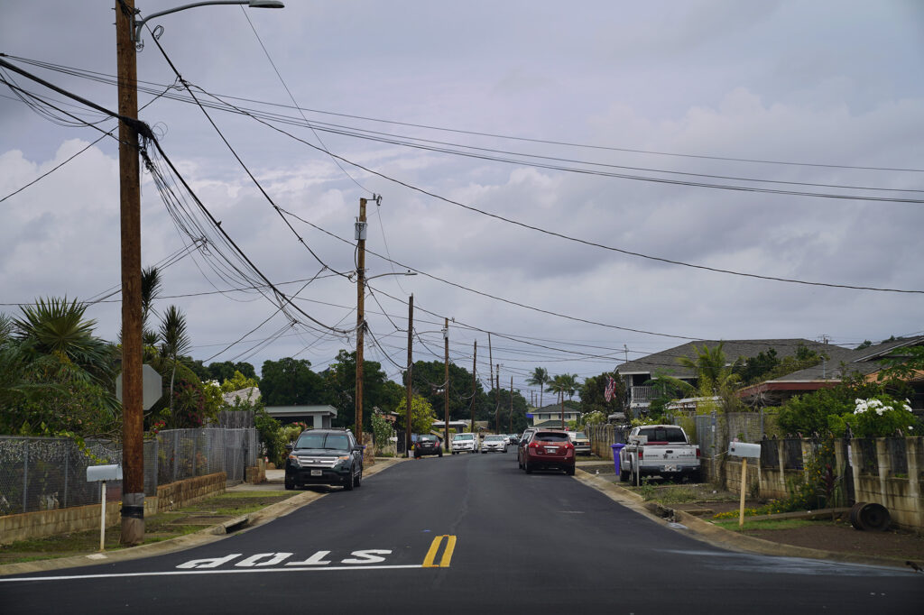 An ʻEwa Beach neighborhood lacks sidewalks at the intersection of Imelda and Auwaha Streets Monday, Dec. 15, 2025. (Kevin Fujii/Civil Beat/2025)