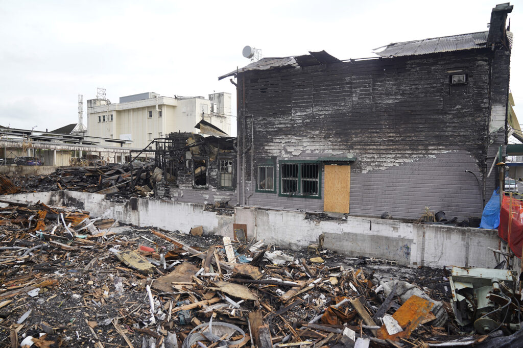 A fire razed the Avani Yoga and Boutique and damaged Olena’s Russian Massage building next door photographed Tuesday, Dec. 16, 2025, in Hilo. Two other recent fires killed three people. One person died at the Wild Ginger Hotel. Two women died at the former poi factory. (Kevin Fujii/Civil Beat/2025)