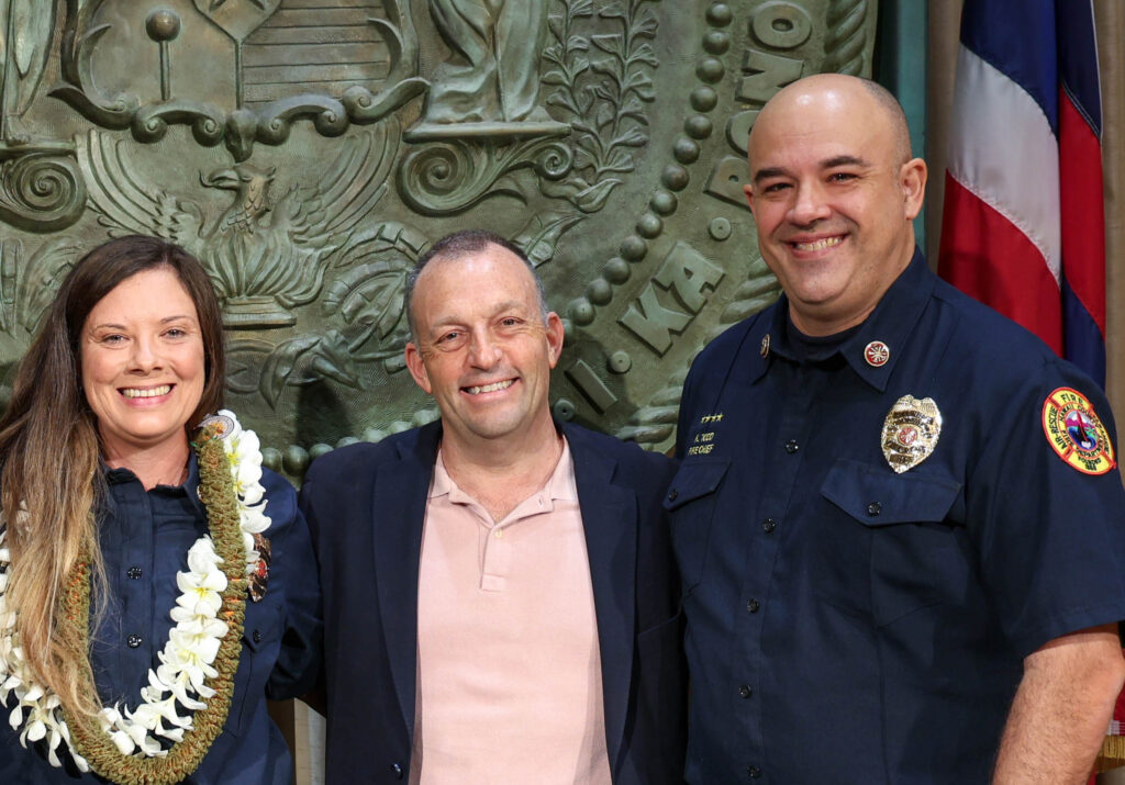 The late Hawaiʻi Fire Chief, Kazuo Todd, (right), Gov. Josh Green, (Center), and Hawaiʻi State Fire Marshal Dori Botth, (left.)