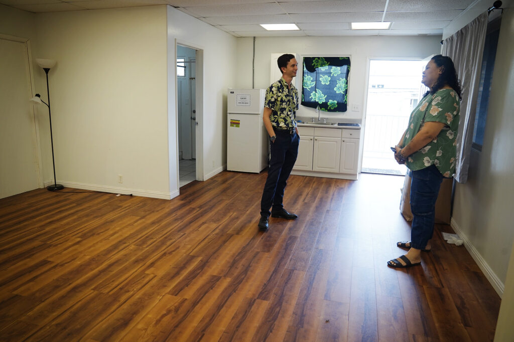 Family Promise of Hawaiʻi, Executive Director Ryan Catalani, left, chats with Case Worker Fita Nisa Wednesday, Dec. 17, 2025, in Honolulu. Changes to federal policy are threatening tens of millions of dollars in local funding for homelessness programs and service providers. Family Promise of Hawaiʻi provides services and housing to homeless families. Catalani thinks it could be an opportunity to develop more innovative programs and responses to homelessness if they have to turn to local funding sources. (Kevin Fujii/Civil Beat/2025)