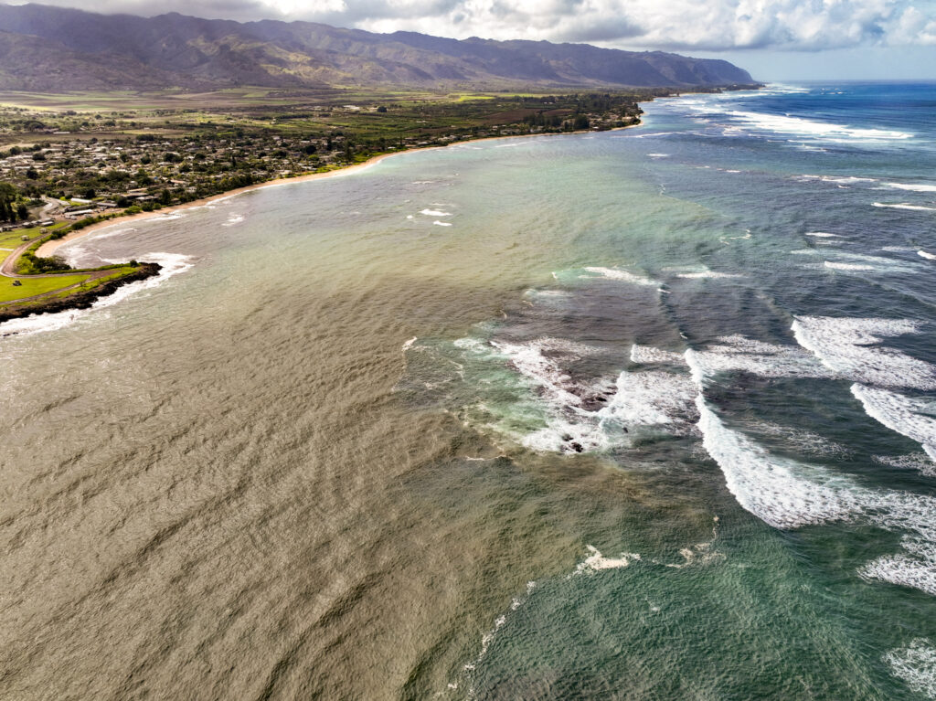 Kaiaka Bay, located on the North Shore of Oʻahu, turns brown after rains wash soil into the waters, Wednesday, Dec. 17, 2025. (Nathan Eagle/Civil Beat/2025)