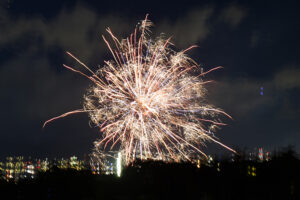 A Department of Law Enforcement drone flies near an aerial firework Wednesday, Dec. 31, 2025, as seen from Waipahu. New laws, the use of aerial drones and citizens heeding the dangers of fireworks noticeably  curbed the annual personal pyrotechnics. (Kevin Fujii/Civil Beat/2025)
