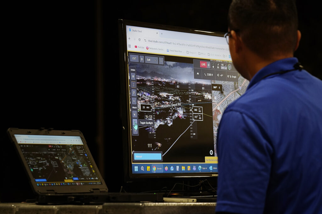 A Department of Law Enforcement drone pilot watches his screen Wednesday, Dec. 31, 2025, in Waipahu. New laws, the use of aerial drones and citizens heeding the dangers of fireworks noticeably  curbed the annual personal pyrotechnics. (Kevin Fujii/Civil Beat/2025)