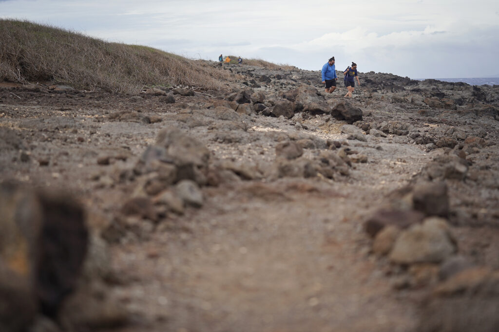 Kaipu Keala and Davianna Pomaika‘i McGregor walk on a  Protect Kahoʻolawe ʻOhana (PKO) trail built and maintained in areas cleared of unexploded ordnance (UXO) Monday, Jan. 5, 2026, in Hakioawa. PKO celebrates the 50th year of sovereign land. (Kevin Fujii/Civil Beat/2026)