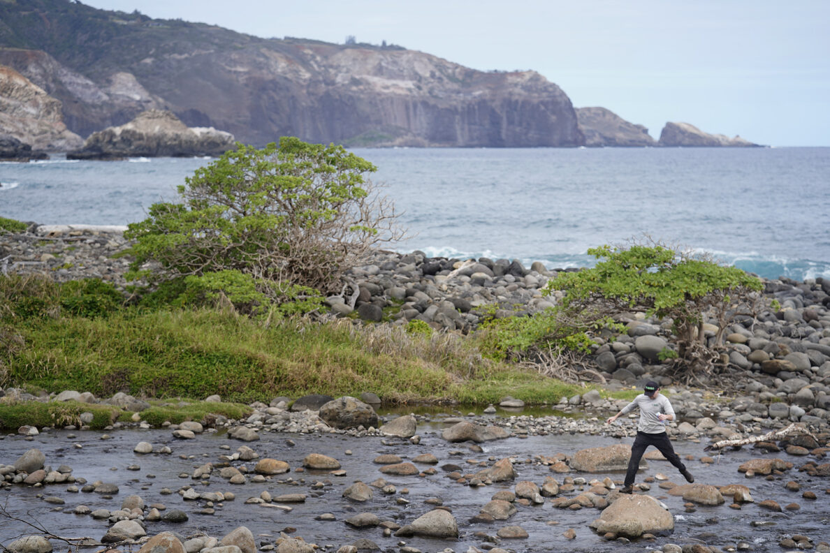 Maui Invasive Species Committee field crew Liam Andersen crosses the Waihe‘e River after checking for little fire ants on the opposite side of the Waihe'e Coastal Dunes and Wetlands Refuge Tuesday, Jan. 13, 2026, in Waihee-Waiehu. (Kevin Fujii/Civil Beat/2026)