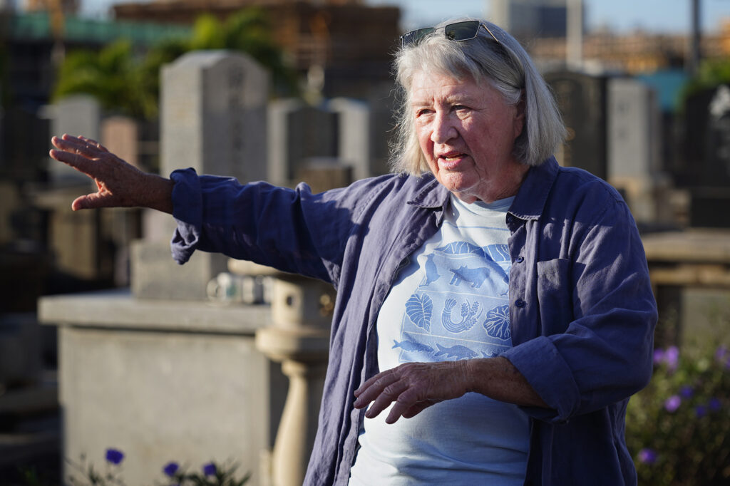 Laura Ruby is photographed at the Mōʻiliʻili Japanese Cemetery Friday, Jan. 9, 2026, in Honolulu. Ruby opposes the pedestrian bridge over the Ala Wai Canal connecting Mōʻiliʻili and Waikīkī. (Kevin Fujii/Civil Beat/2026)
