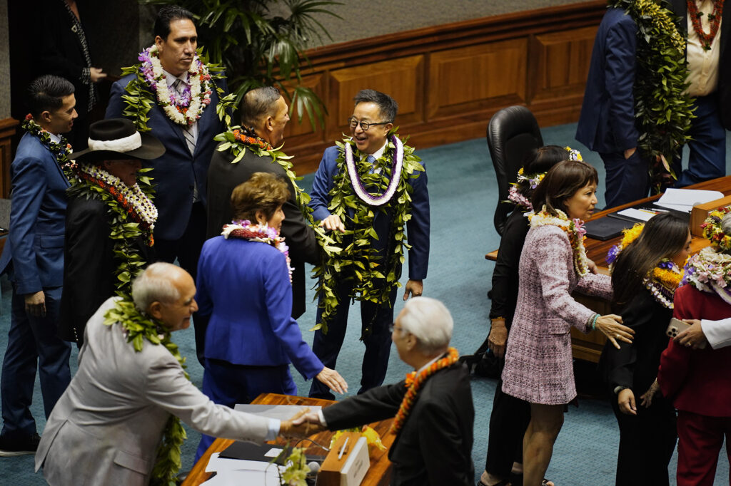 Sen. Glenn Wakai, center, greets Sen. Kurt Fevella before the Hawaiʻi State Legislature opens Wednesday, Jan. 21, 2026, in Honolulu. (Kevin Fujii/Civil Beat/2026)
