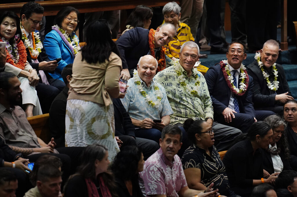 Maui Director of Communications and Government Affairs Laksmi Abraham gets smiles for a photo from Honolulu Mayor Rick Blangiardi, from lower left, Maui Mayor Richard Bissen, Kauaʻi Mayor Derek Kawakami, Hawaiʻi Mayor Kimo Alameda, Lt. Gov. Sylvia Luke, from upper left, U.S. Sens. Brian Schatz and Mazie Hirono and Gov. Josh Green The Hawaiʻi State Legislature opens Wednesday, Jan. 21, 2026, in Honolulu. (Kevin Fujii/Civil Beat/2026)