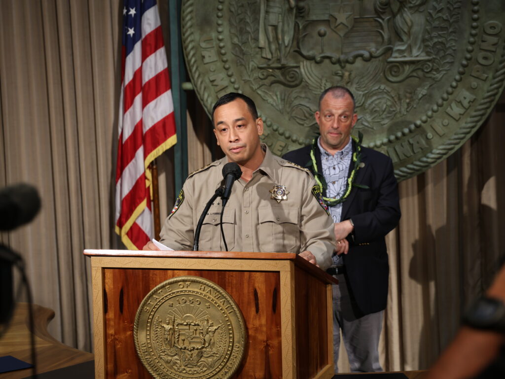 Maj. Mike Lambert and Gov. Josh Green during a bill signing June 30 for new legislation related to fireworks safety.
