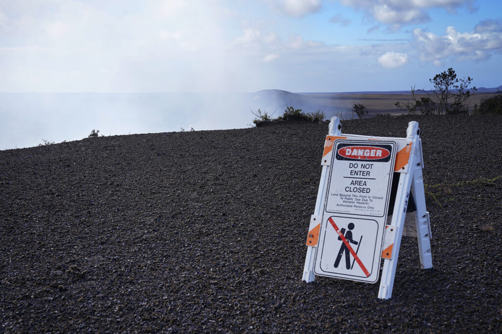 Halema‘uma‘a Crater degasses behind a tephra and Pele’s hair covered landscape at Hawaiʻi Volcanoes National Park after Kīlauea’s 41st episode Thursday, Feb. 5, 2026, in Volcano, Hawaiʻi Island. (Kevin Fujii/Civil Beat/2026)