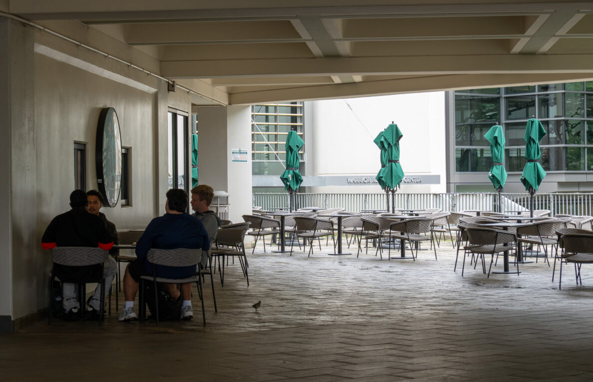 Zebby Zarwie, left, and friends at the UH Campus Center, Monday Feb. 9, 2026. The friends gathered for a regular Bible study session at a usually bustling student union. (Craig Fujii for Civil Beat)