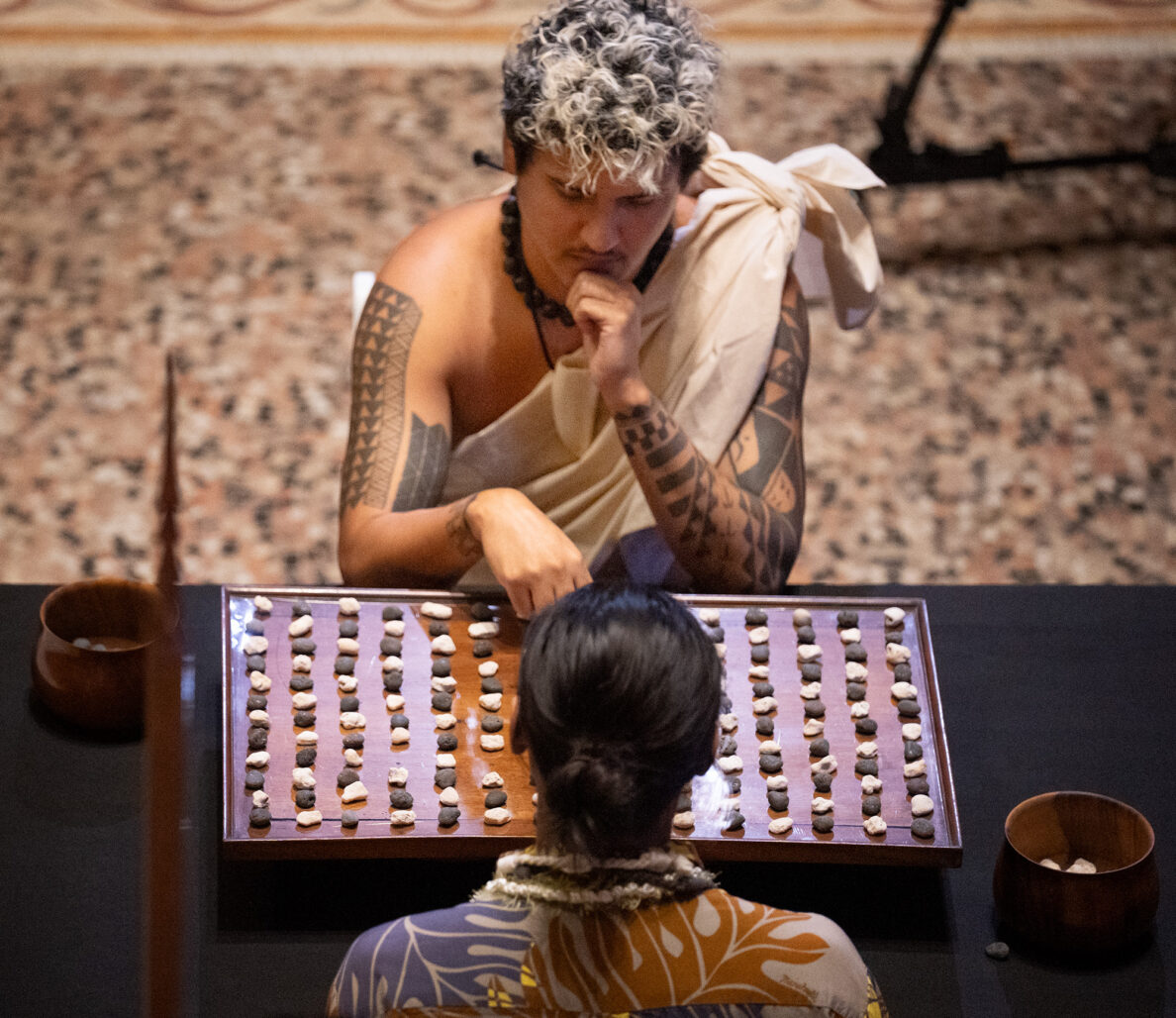 An all-Oʻahu championship match between Kapena Baptista, top, and Kahekili Yung, takes place during the inaugural Ka Makou Kōnane Invitational Tournament in the center of the Bishop Museum’s Hawaiʻian Hall Friday, Feb. 13, 2026, in Honolulu. (Kevin Fujii/Civil Beat/2026)