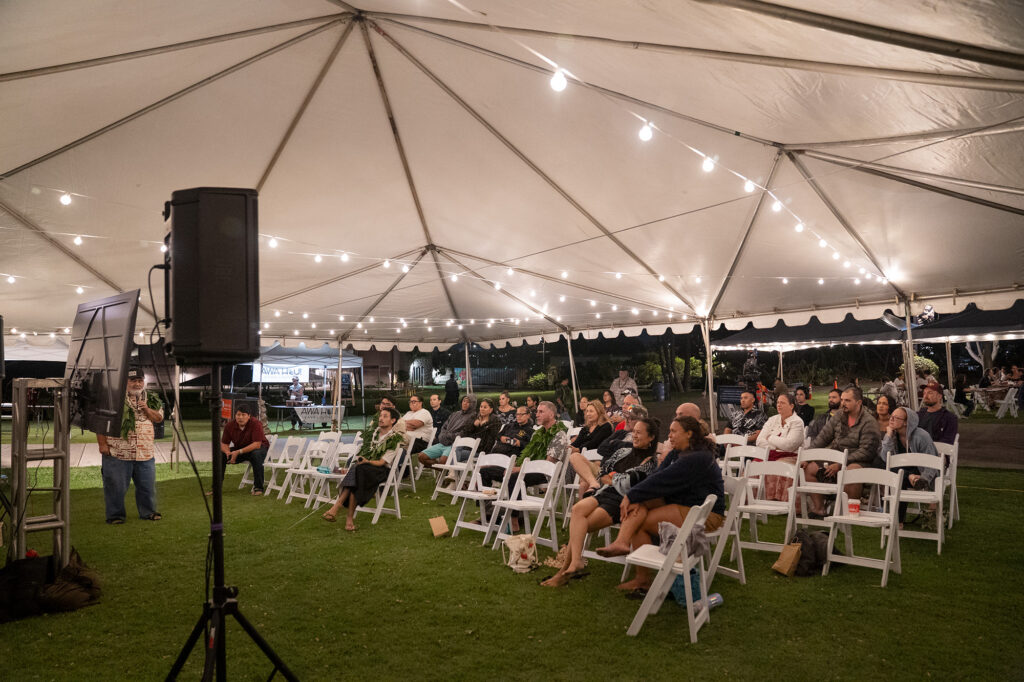 A crowd on the gallery lawn watches the inaugural Ka Makou Kōnane Invitational Tournament championship match between O‘ahu’s Kahekili Yung and Kapena Baptista at the Bishop Museum Friday, Feb. 13, 2026, in Honolulu. (Kevin Fujii/Civil Beat/2026)
