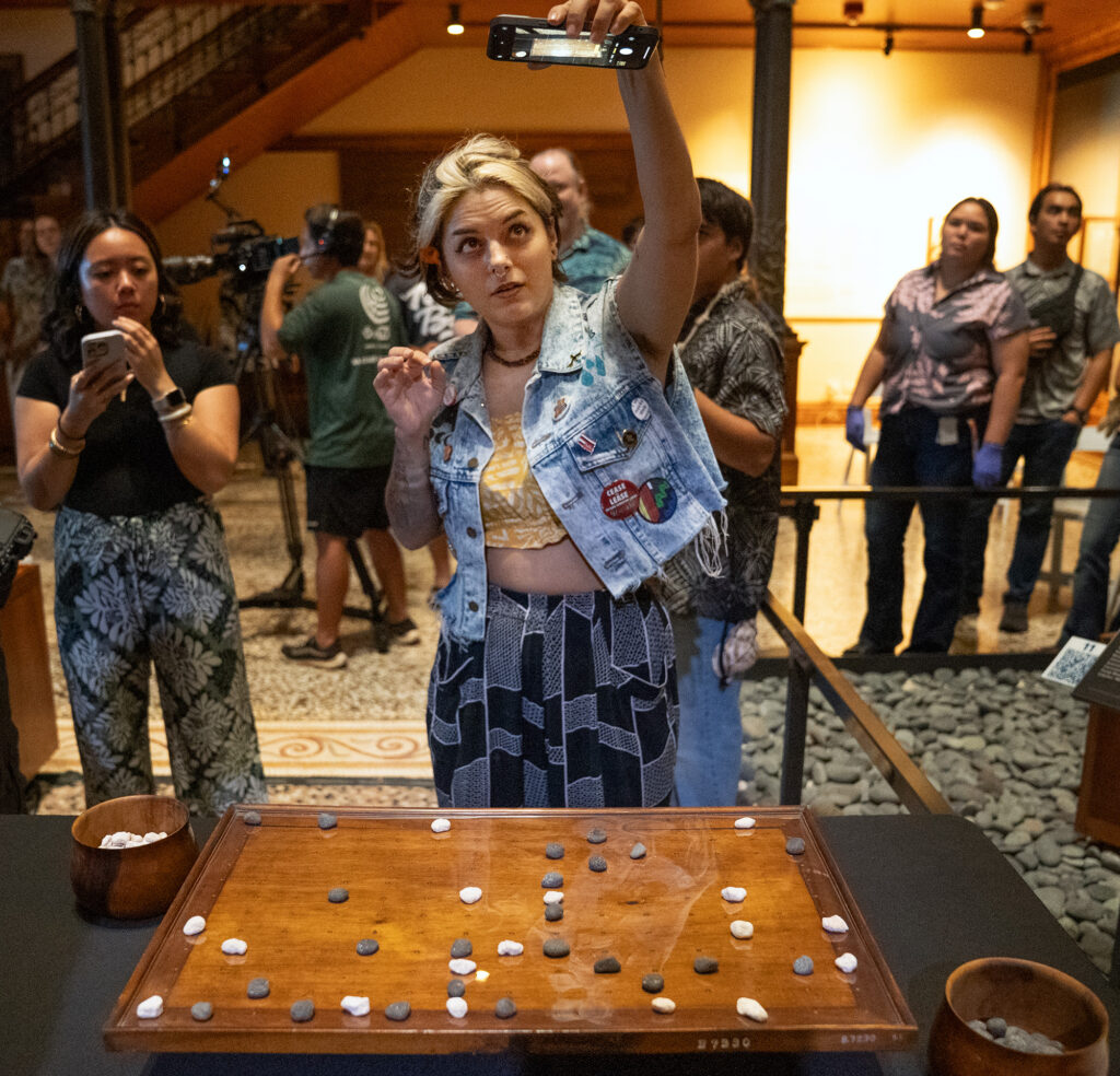 Kūna‘e Kamahele captures the final play Kapena Baptista made against Kahekili Yung on the Kūpuna Papamū to win the inaugural Ka Makou Kōnane Invitational Tournament at the Bishop Museum Friday, Feb. 13, 2026, in Honolulu. (Kevin Fujii/Civil Beat/2026)