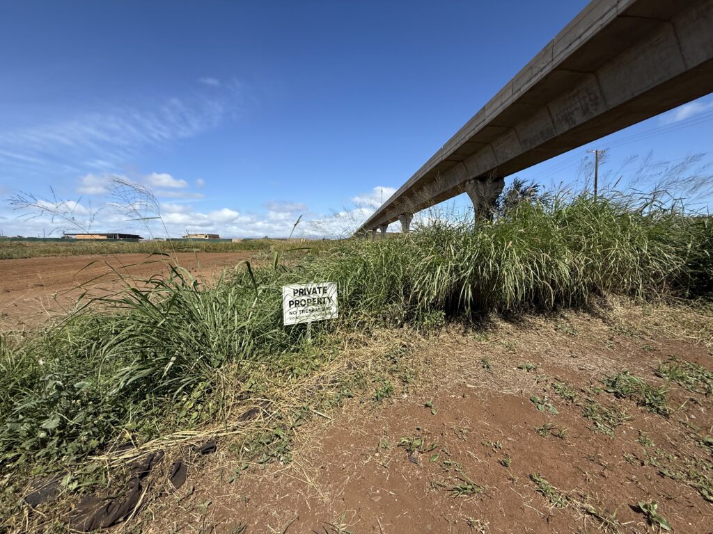 A No Trespasing sign on land adjacent to the Honolulu Skyline's Hoopili station underscorces the lack of amenties at stops along the rail line.